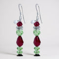Pair of Crystal grinch earrings with Swarovski red and green beads on a white background